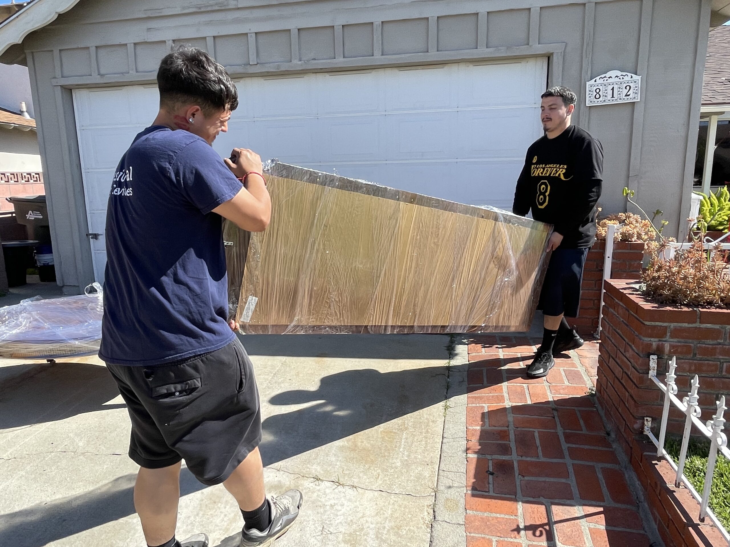 Professional movers carrying a couch in Orange County