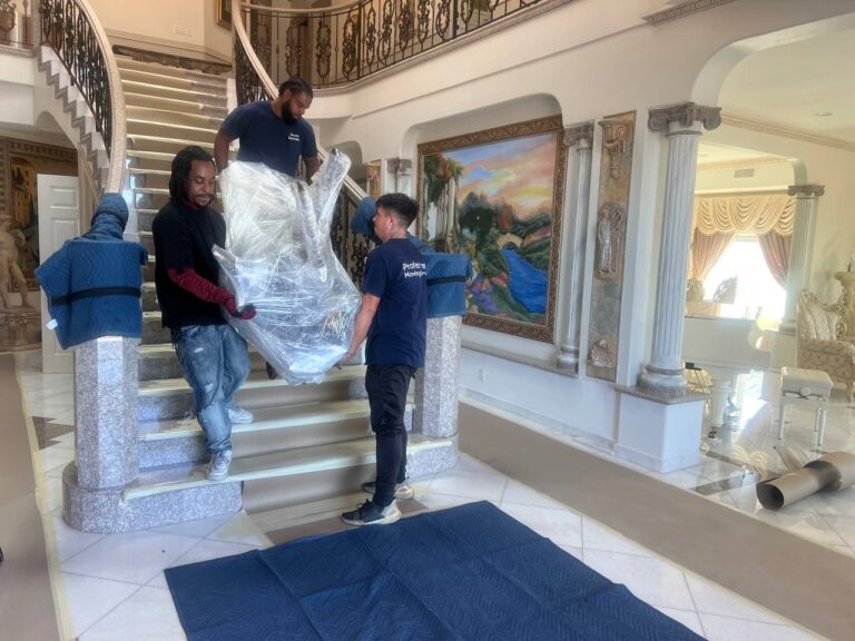 Residential moving team carrying furniture in Orange County