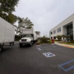 OC moving company truck parked by the beach, ready to help locals move with care