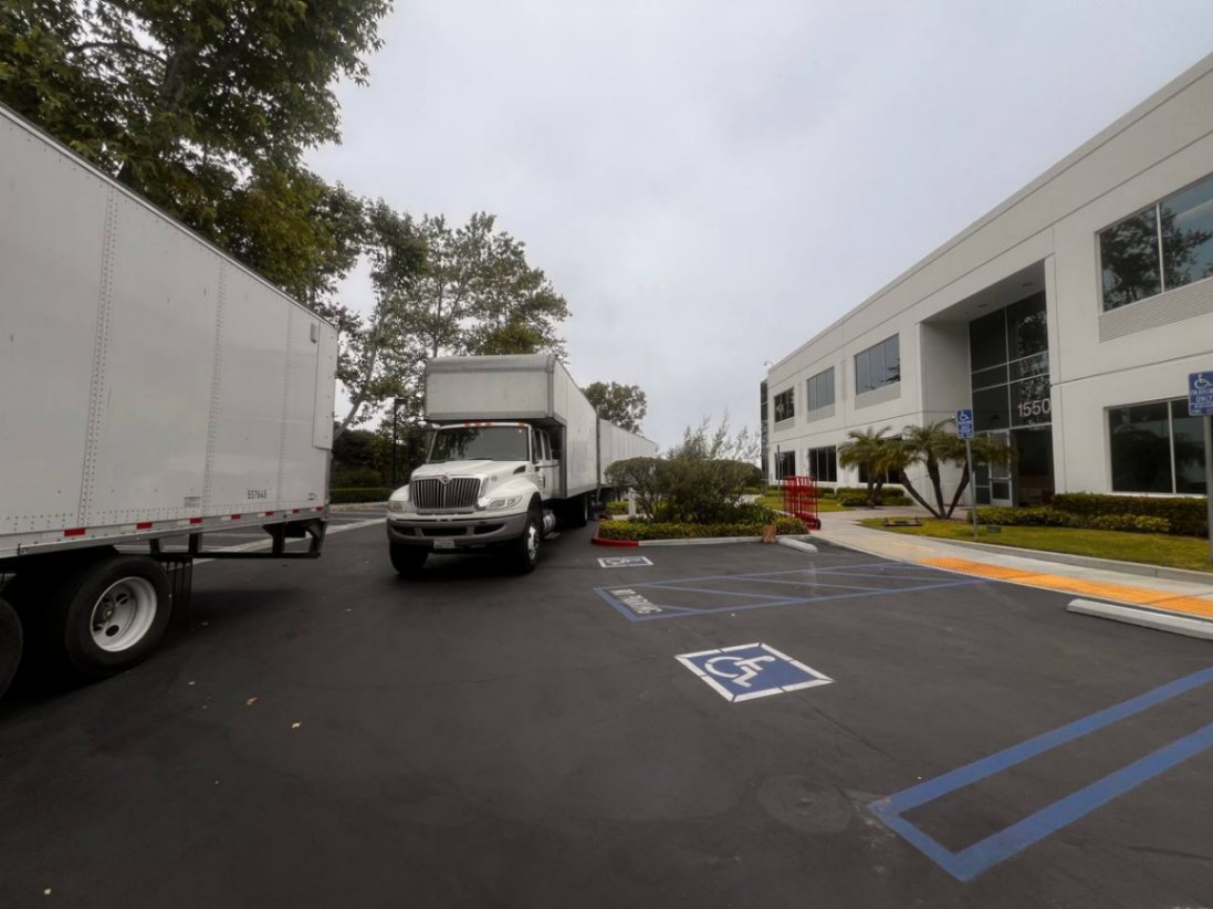 OC moving company truck parked by the beach, ready to help locals move with care