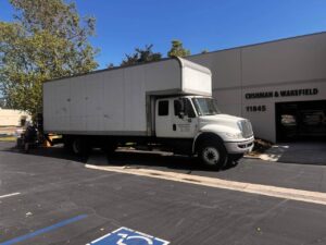 Professional movers in Costa Mesa loading boxes into a truck