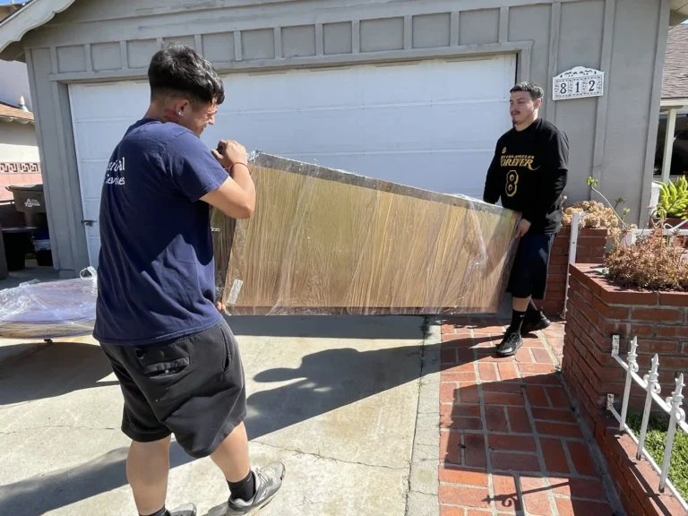 Professional movers carrying a couch in Orange County